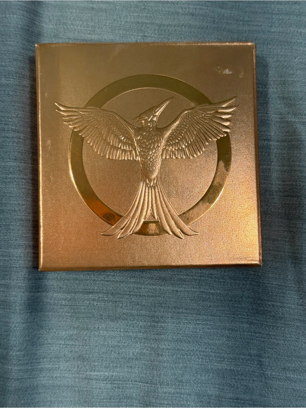 Gold Metallic Box with Embossed Bird Emblem hunger games bronzer makeup